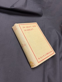 A hardback book bound in pale olive green bookcloth with red text and details on the cover and spine
