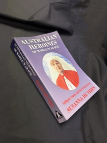 Paperback book with purple blue cover & spine, red and white text one cover & spine, black logo and text on spine and colour image of a woman in army nurses uniform on cover