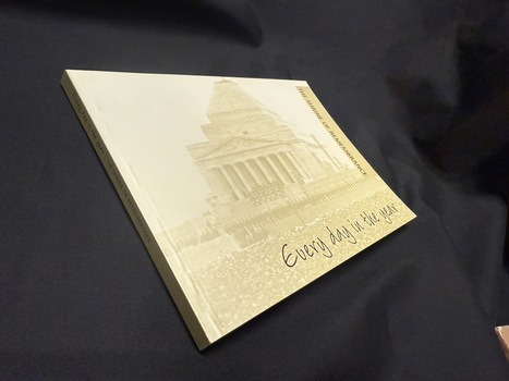 Paperback book with faded photograph of Melbourne Shrine of Remembrance as background of covers and spine with black text used
