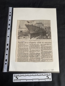 A newspaper clipping with a black and white photo of a ship at the top and three columns of text underneath. 