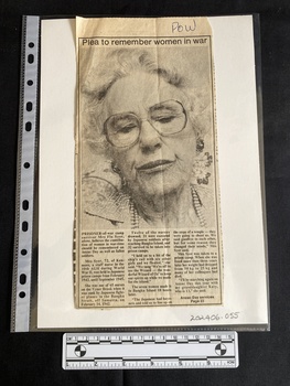 Newspaper clipping with large black and white photo of an older woman and three columns of text underneath