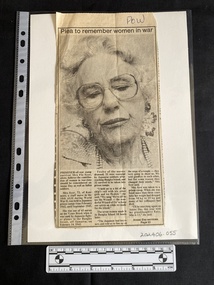 Newspaper clipping with large black and white photo of an older woman and three columns of text underneath