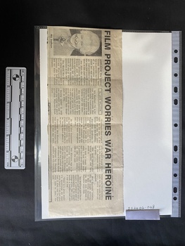 Newspaper clipping with a photo and four columns of text