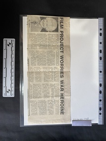 Newspaper clipping with a photo and four columns of text