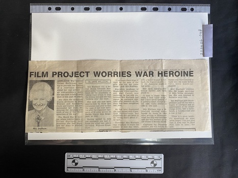 Newspaper clipping with a black and white photo of an older woman and four columns of text
