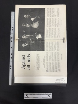 Photocopy of a double page spread of a journal article with a large black and white photograph of four army nurses in uniform, this spread has six columns of text