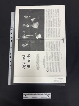 Photocopy of a double page spread of a journal article with a large black and white photograph of four army nurses in uniform, this spread has six columns of text