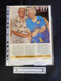 Second page of a magazine clipping consisting of three columns of text under a large colour photo of an older man and woman