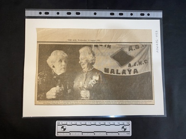 A newspaper clipping of a large black and white photo featuring two older women