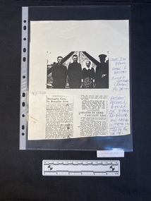 Photocopied page of two single column newspaper clippings beneath a photo of four people