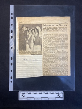 Newspaper clipping of a black and white photo and a story of two columns of text