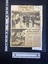 A newspaper clipping of two black and white photos, one large, and a short story in two columns glued to a lined sheet of paper