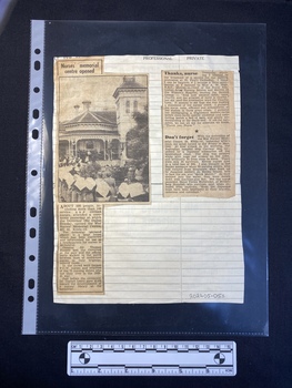 Two newspaper clippings have been glued to a lined sheet of paper.  The left hand clipping consists of a large black and white photo and a column of text, while the right hand clipping is of two separate paragraphs of text.