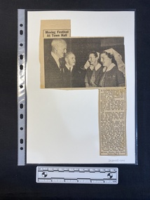 A newspaper clipping of a large black and white photo with a single column of text beneath