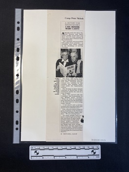 A photocopy of a magazine clipping of a single, long column of text that includes a small black and white photo