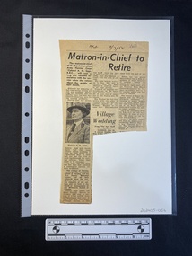 A newspaper clipping of a story with three columns of text, including a small black and white photo