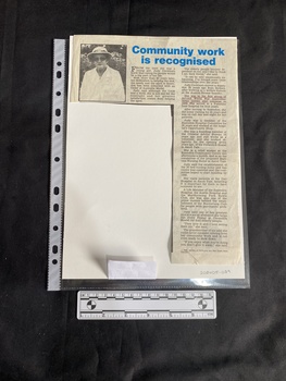 A newspaper clipping featuring a blue title, two columns of text and a small black and white photo