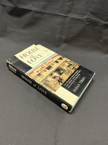 Hardback book with a torn dust jacket.  Dust jacket is black and white with a colour photograph of a street scene in front of a hospital building.