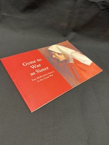 Booklet with red cover and spine, white writing and the image of a painting of a nurse in uniform on the cover.