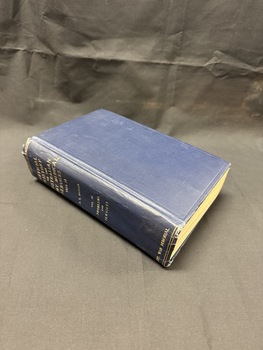 Hardback book bound in navy blue book cloth with gold writing on spine, book shows wear.
