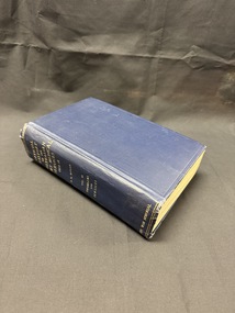 Hardback book bound in navy blue book cloth with gold writing on spine, book shows wear.