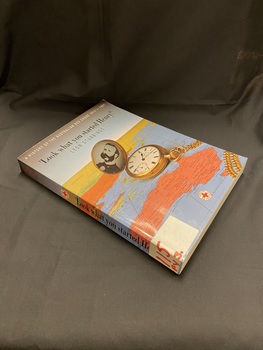 Paperback book with a bluish grey cover and a map of the world, predominantly showing Australia, on the front cover and spine. Main heading is in black text and subheading is in white text (cover) and red text (spine). There is an open gold pocket watch on the map with a black and white photo of a gentleman displayed inside.