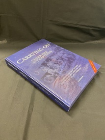 Hardcover navy blue book with title, subheading and author in white print. There is a red strip across the bottom right corner that reads 'memorial edition'. The title information is printed over an image of six men in uniform posing in front of a vehicle , a list of names, and a symbol of the Australian Army Medical Corps.