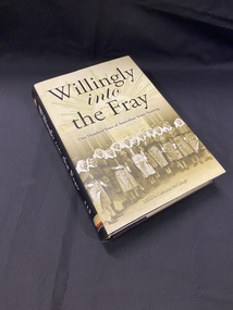 Black hardcover book with dustjacket. Dustjacket has a black spine with white writing. Front cover of dust jacket is a sepia tone image of 14 female nurses in uniform standing in front of the Australian General Hospital in 1942.