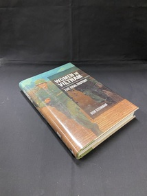 Cream coloured hardcover book with an olive green spine. The green continues an inch onto the front and back covers and the title and author are printed in gold along the spine. The book is covered in a dust jacket depicting a female in combat clothing running through a military base followed by a stretcher bearer. A darker rectangle overlays the right side of the cover containing the title and the author name in white text.