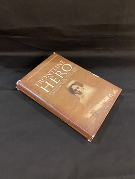 Brown hardcover book with  an image of the face of a female nurse in sepia tones in the centre of the front cover. The title heading above this image is printed in white and above that, at the top of the page, it reads 'transcribed by Jan Leader and Graeme Mitchell'. At the bottom of the front cover is a feint image of rows of white tents with six men wandering in front of them. The dust jacket is an exact replica of the hardcover inside.