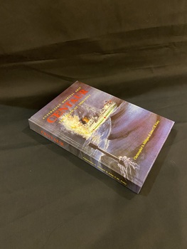 Purple and black hardcover book with title printed in red print on the spine. At the top of the front cover is 'Australian hospital ship' printed in yellow, followed by 'Centaur" in larger red type and 'the myth of immunity in smaller yellow type. The cover shows an image of a medical ship sailing on rough waters with what looks like an explosion happening at the back of the ship. There is no dust jacket.