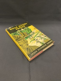 Hardcover book with a dustjacket firmly attached. There is a black panel across the top with the title in yellow print and another thinner black panel across the bottom with the author's name in cream coloured print. The front cover shows an illustration of a Japanese soldier in the foreground and behind him are eight women working in a field, they are being watched by an armed soldier stationed at a lookout on a wall behind them. The image is in black, green and yellow.