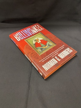 Bronze coloured hardcover book with gold writing on the cover depicting title and auther's name. The book is covered with a brown and red dust jacket with an image on the cover of a framed oil painting of Vivian Bullwinkel wearing her nurses' uniform.