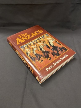 Brown hardcover book with a brown dust jacket. Both the front cover and spine of the dust jacket show the title and a brown and white drawn image of lines of soldiers marching in uniform.