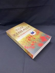 Paperback book with a light olive cover and an image of a poppy field under the title and the author's name.