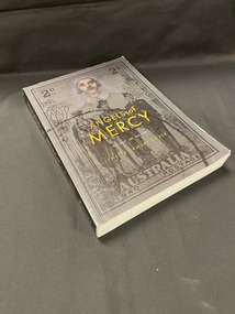 Black paperback book with 'ANGELS of MERCY' printed in gold writing in the centre of the cover, below this is 'FAR WEST' 'FAR EAST' in smaller white print and below that is the author's name in gold uppercase. In the background, covering the whole front cover is a faded black image of a 2d Australia 1940 postage stamp. The stamp depicts three military men (representing the navy, army and air force) standing in a line and an image above them of military nurse