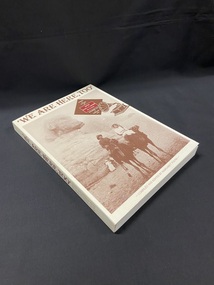 Cream coloured book with title printed in brown text across the top. Under the title is a large rectangle photo of a man and a woman riding two camels in Egypt in sepia tones. At the top of the image is a diamond with the subtitle printed inside, and inside that is a maroon rectangle with the author's name printed in white text. Next to this shape is an image of a gramaphone.