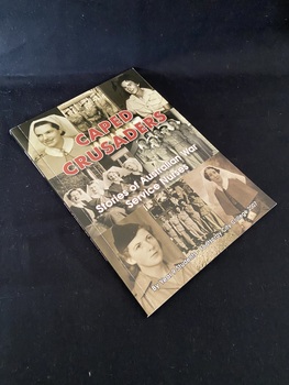 Paperback book with black spine. The cover shows eight photos of Australian War Nurses in black and white (four individual photos and four group photos). The title is overlaid in maroon lettering and the sub-heading and author details in white print.