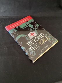 Paperback book with the title written across the lower part of the cover in white and cream text, above that is a white flag with a red cross. There is a red panel across the top with the subtitle printed inside. The rest of the cover shows a blurred green and black image of soldiers.