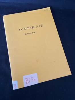 Yellow stapled booklet with 'FOOTPRINTS' printed across the centre towards the top of the page and 'by Grace Trott' printed below. There is a white sticker on the spine and the bottom of the cover that reads B136 in red ink.