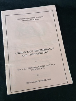 Paper booklet with two staples. The cover is pink paper with white pages inside. There is a black straight border around the edge and details of the service are printed in black ink.