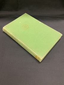 Green cloth bound book with a gold compass symbol on the front cover and gold printed heading and author on the spine.