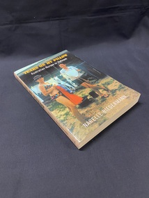 Peach coloured spine with olive printed text. Cover shows a photograph of two nurses in Vung Tau in 1968 standing by a clothes line and hanging up washing, one is wearing swimwear and the other is wearing shorts and top.
The title is printed across the top in yellow print and the sub title below that in white print.