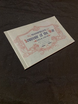 Olive green paperback book. The title is printed in black ink in the middle of the cover, it is surrounded by a very ornate deep red border.