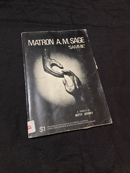 Stapled booklet with black cover. Title and authors name are printed in white on the front cover along with phograph of a sculpture of two hands reaching towards each other ['hands' by Henry Moore].