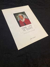Paperback book with a white cover. There is a rectangle border in the middle of the cover and inside is a painting Of Ada Joyce Bridge wearing her nurses uniform, The title is printed under the image. The sub title and author's name are printed below the rectangle template towards the bottom of the cover.