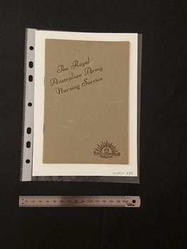 Thin, olive green booklet with two staples in the spine. The title is printed in brown ink on a slight diagonal angle towards the top of the cover. There is the Australian Commonwealth Military Forces emblem in the bottom right corner, also printed in brown ink.