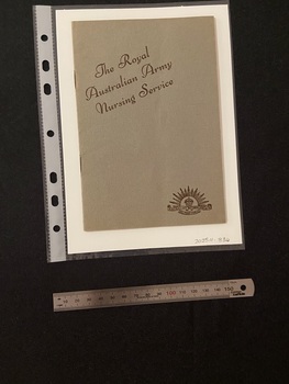 Thin, olive green booklet with two staples in the spine. The title is printed in brown ink on a slight diagonal angle towards the top of the cover. There is the Australian Commonwealth Military Forces emblem in the bottom right corner, also printed in brown ink.