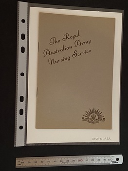 Thin, olive green booklet with two staples in the spine. The title is printed in brown ink on a slight diagonal angle towards the top of the cover. There is the Australian Commonwealth Military Forces emblem in the bottom right corner, also printed in brown ink.