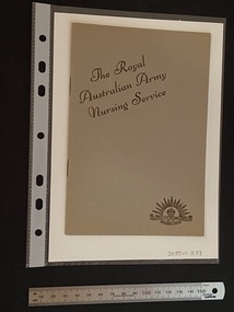 Thin, olive green booklet with two staples in the spine. The title is printed in brown ink on a slight diagonal angle towards the top of the cover. There is the Australian Commonwealth Military Forces emblem in the bottom right corner, also printed in brown ink.